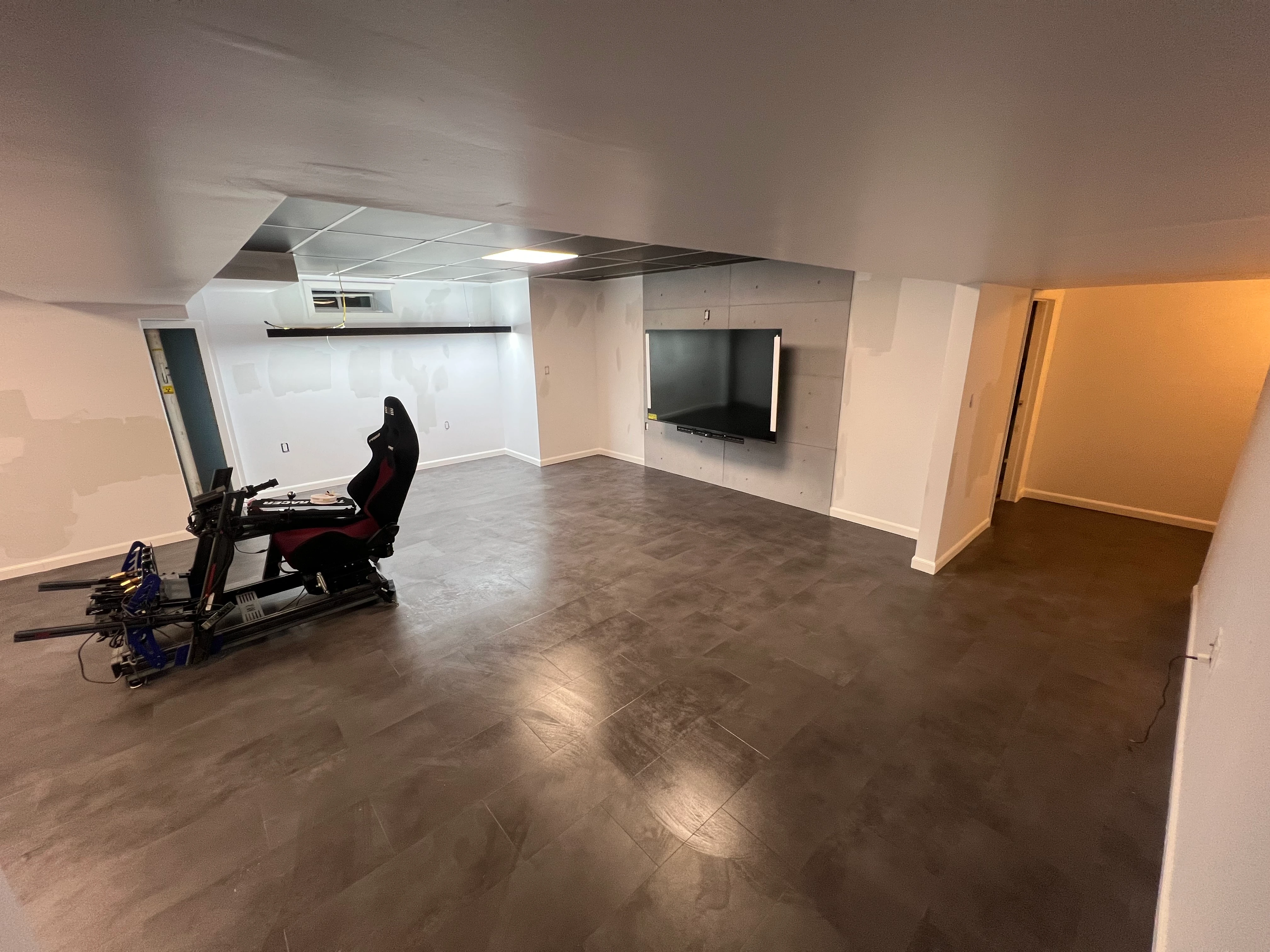 Basement before — exposed joists and concrete